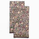 Decorative kitchen towels with floral and leaf pattern on a white background