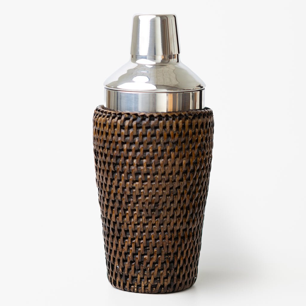 Woven brown cocktail shaker and silver top on a white background