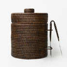 Woven brown basket with a handle on a white background