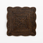 Brown woven square placemat on a white background