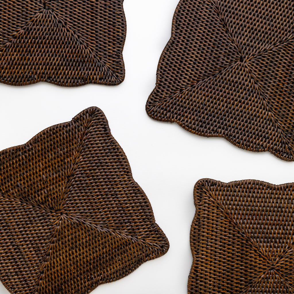 Four brown woven placemats on a white background