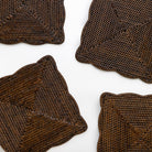 Four brown woven placemats on a white background