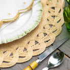 Woven placemat on a wooden table with cutlery