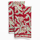 Two red and green patterned towels on a white background