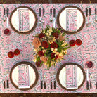 Dining table setting with floral centerpiece on a patterned tablecloth