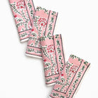 Set of pink floral patterned napkins on a white background