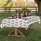 Dining table set with floral arrangements and wine glasses outdoors