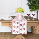 Table setting with a floral arrangement, wine glasses, and a decorative table runner.