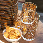 Set of 4 bourbon glasses with gold motifs.