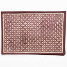 Patterned rug with geometric design on a white background