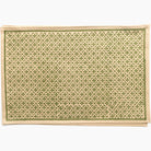Patterned placemat with green and beige design on a white background