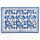 Blue floral patterned rug on a white background