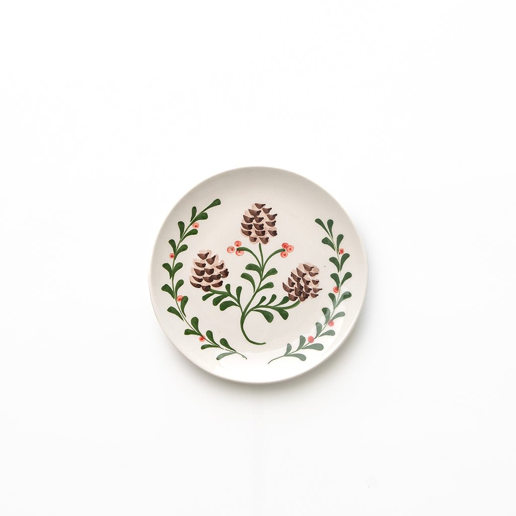 Round ceramic plate with floral design on a white background