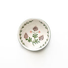 Decorative ceramic bowl with floral patterns on a white background