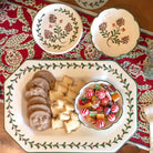 Decorative plate with cookies and candy on a patterned tablecloth