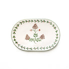 Decorative oval plate with floral and pine cone design on a white background