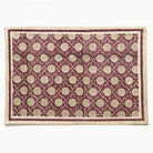 Patterned placemat with beige flowers on a red background