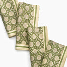 Set of green and beige patterned napkins on a white background