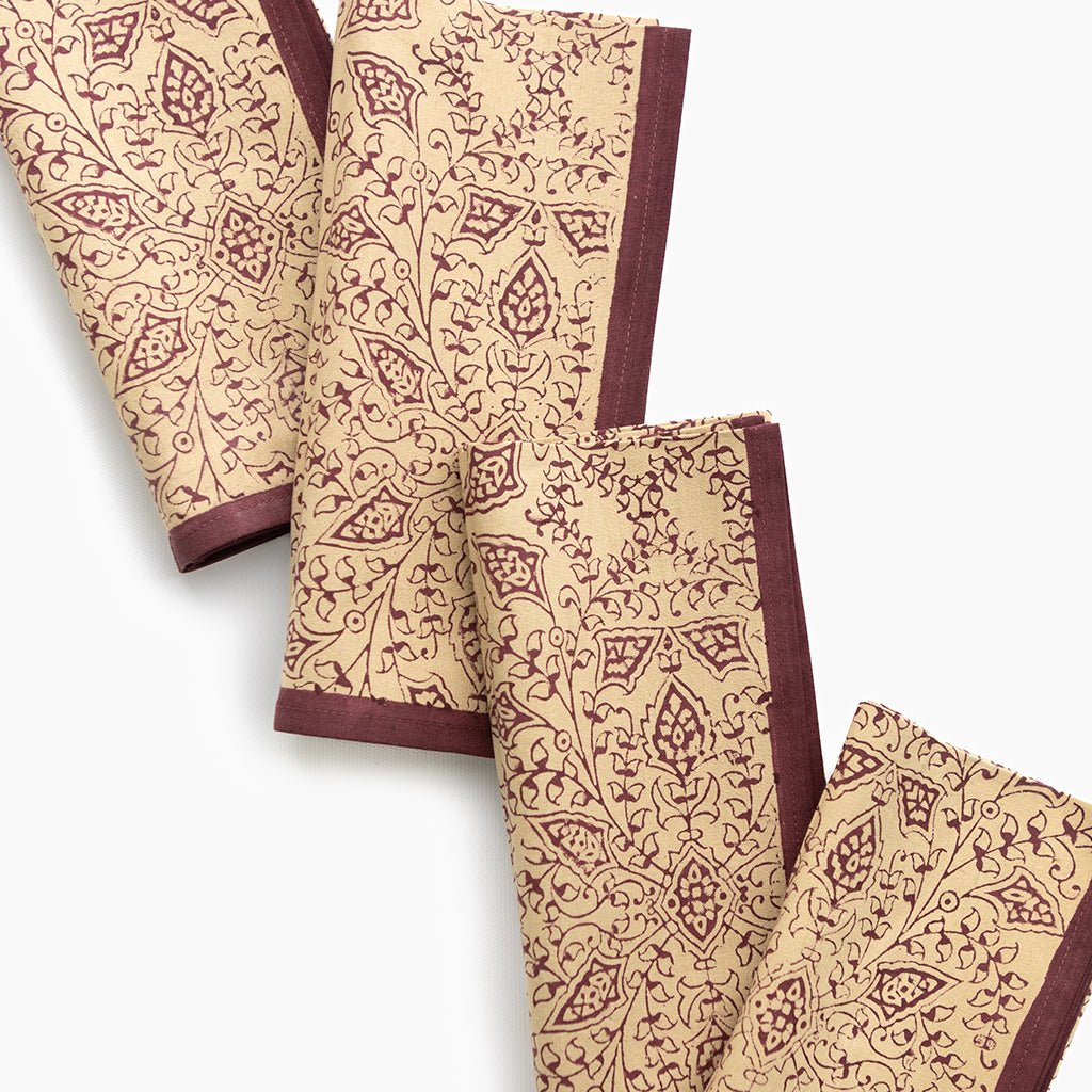 Set of beige napkins with brown pattern on a white background