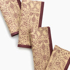 Set of beige napkins with brown pattern on a white background