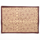 Decorative placemat with intricate pattern on a beige background