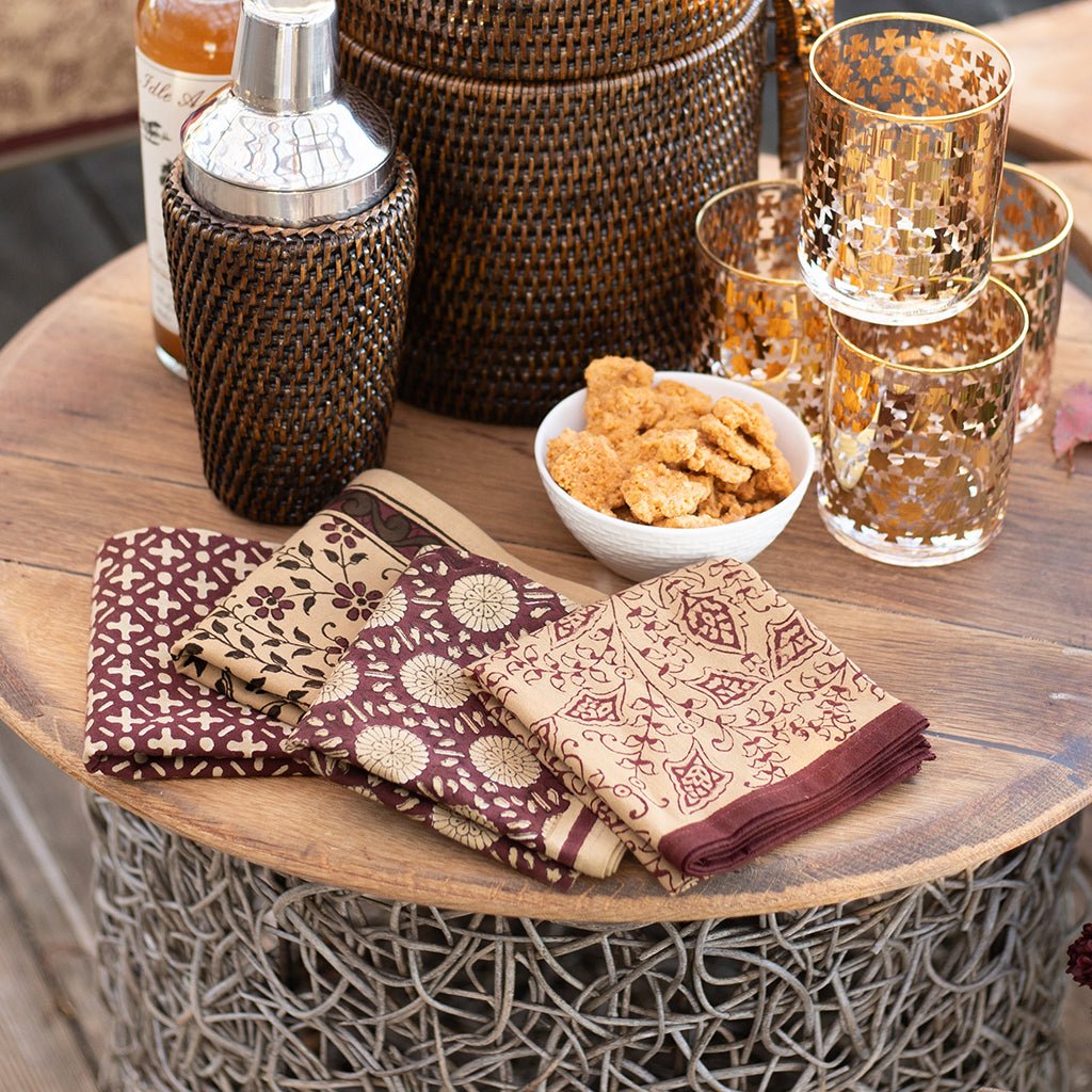 Set of 4 mixed napkins with rattan barware and bourbon glasses.