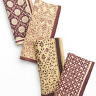 Set of four patterned napkins on a white background