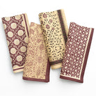 Set of four patterned napkins on a white background