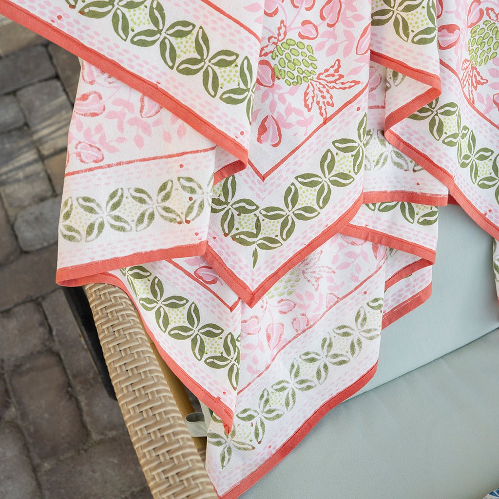 Patterned tablecloth with green and pink design on a chair