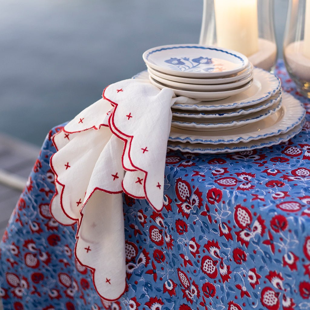 Stack of plates on a tablecloth with a scenic background