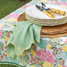 Stack of plates with cutlery on a floral tablecloth