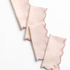 Set of light pink folded napkins on a white background