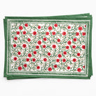 Set of two floral placemats with red flowers and green leaves on a white background