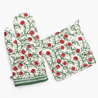 Floral patterned oven mitt and pot holder on a white background