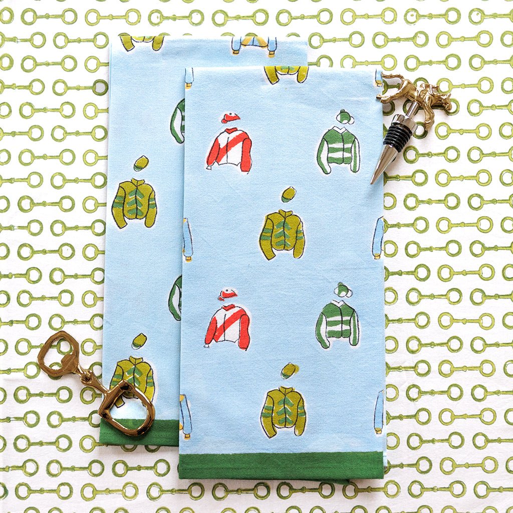 Two blue napkins with jockey silks pattern on a decorative background