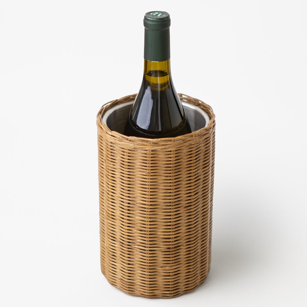 Wine bottle in a rattan holder on a white background
