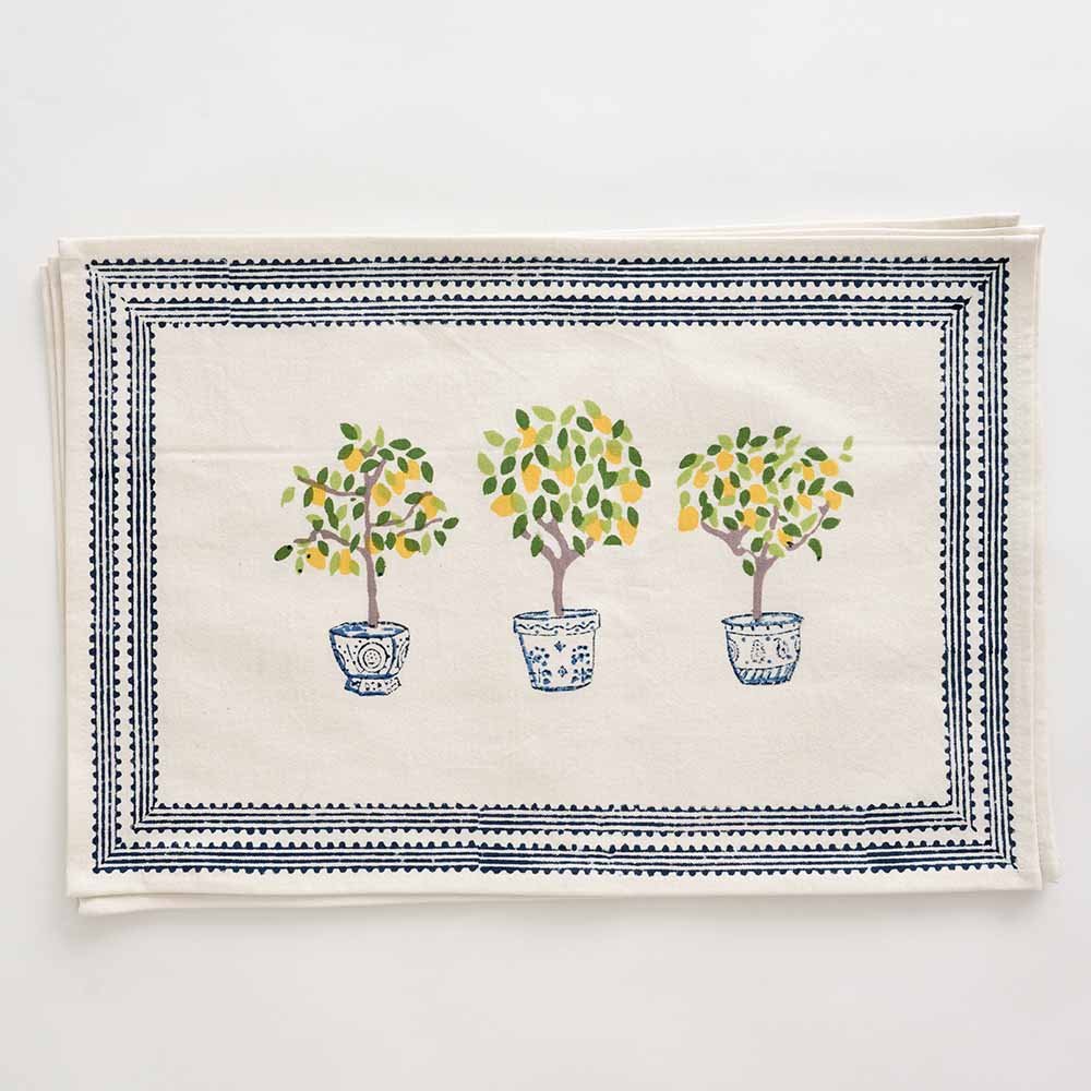 Placemat with three lemon trees and blue border details. 