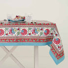 Bohemian tablecloth displaying turquoise, cranberry red, pink, and aqua hues. 