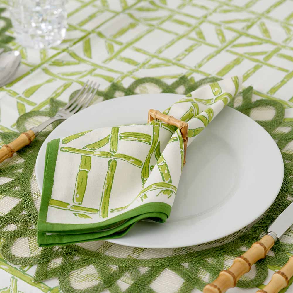 Close up of napkin inside napkin ring and matching tablecloth. 