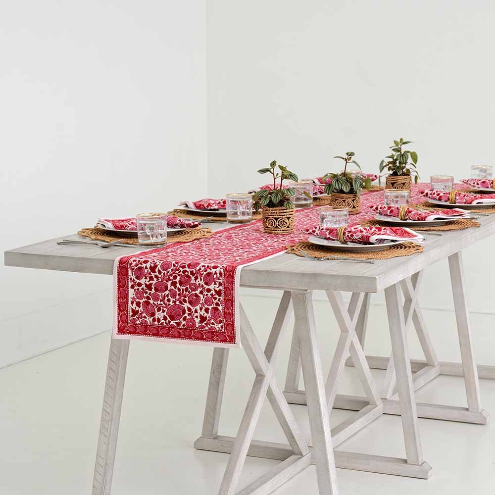 Rose, crimson, and bright pink hues encompass this table runner. 
