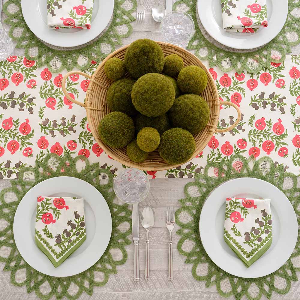 Table runner and matching napkins on white plate. 