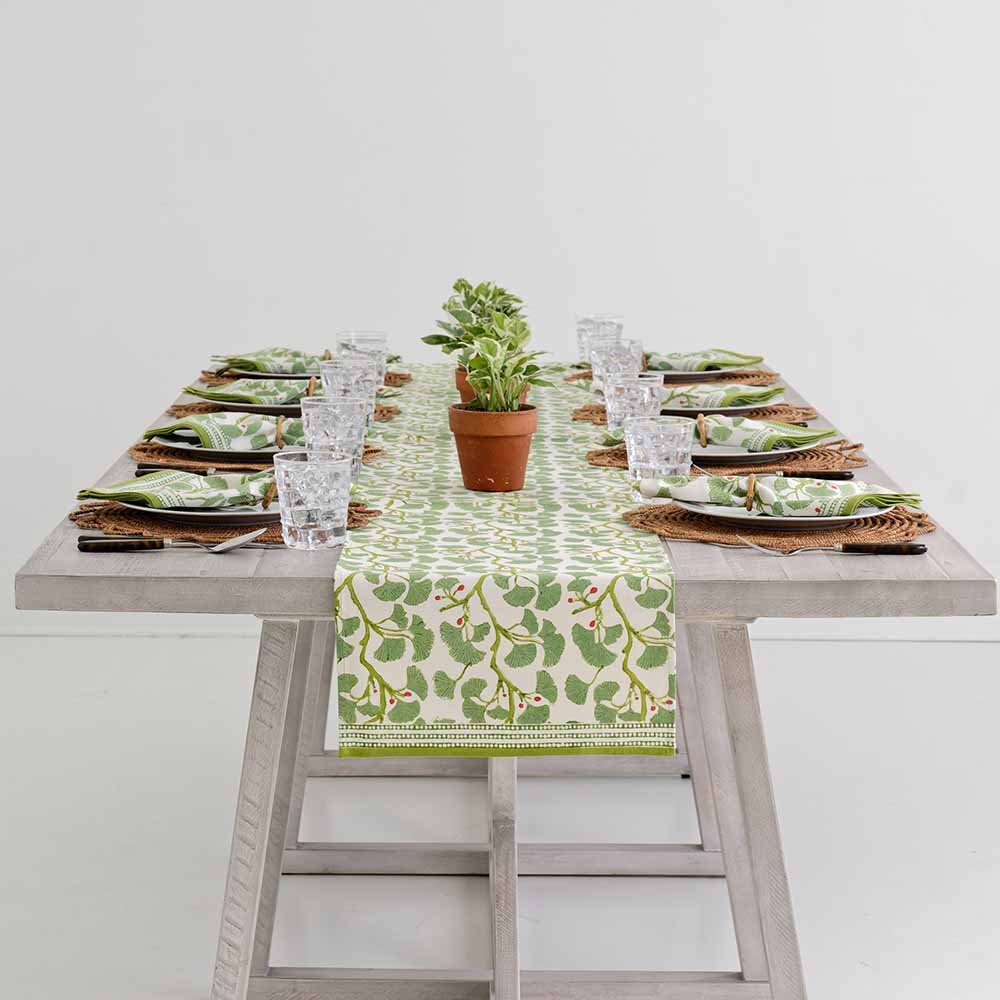 Spring Ginkgo table runner decorating middle of table. 
