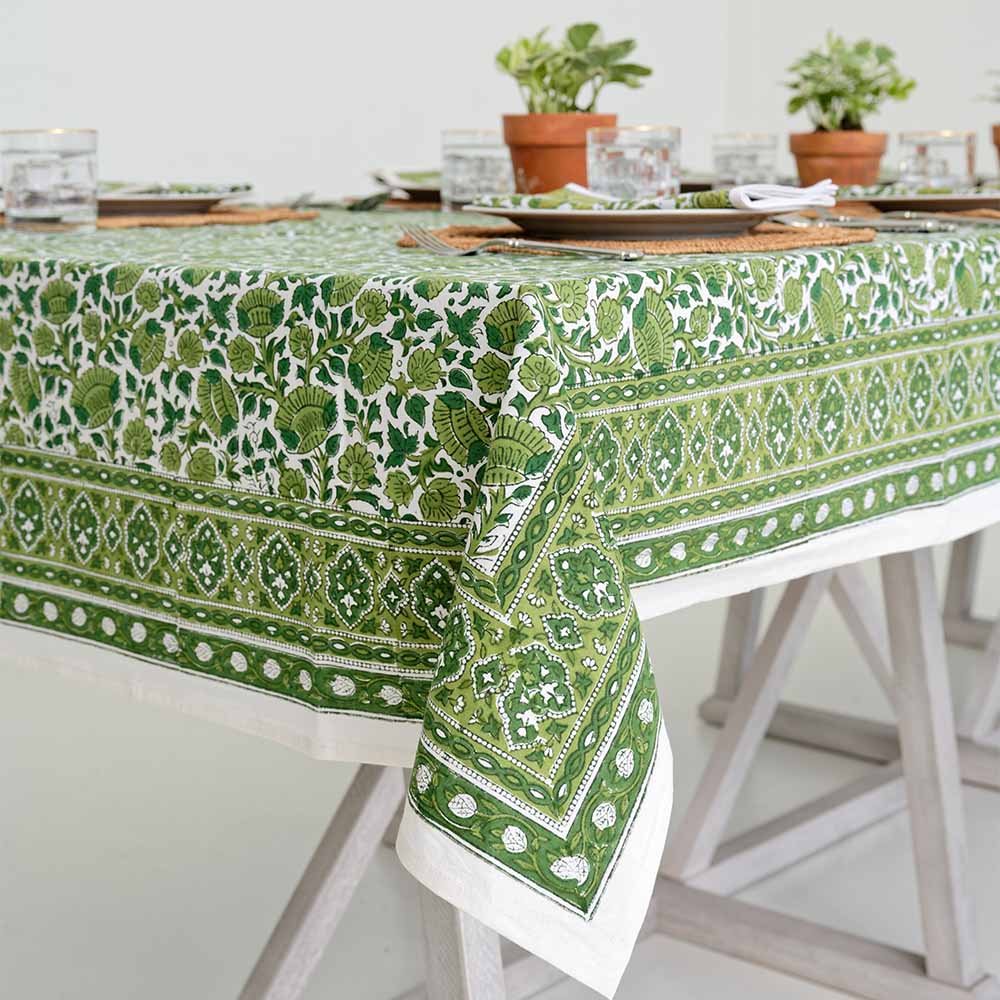 Close up of vibrant green floral design on tablecloth. 