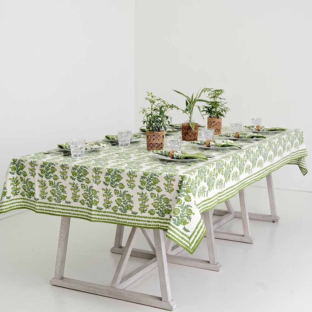 View of dinner table set with Pom Bells Green Tablecloth. 