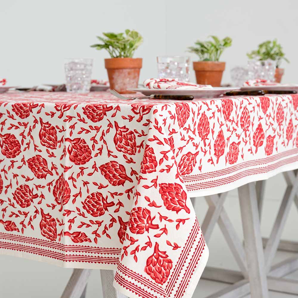 Red and white detailed tablecloth with lined border details. 