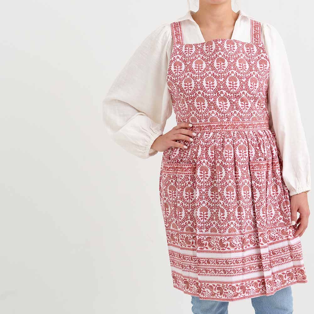 Red and white intricate details encompass this 100% cotton pleated apron. 