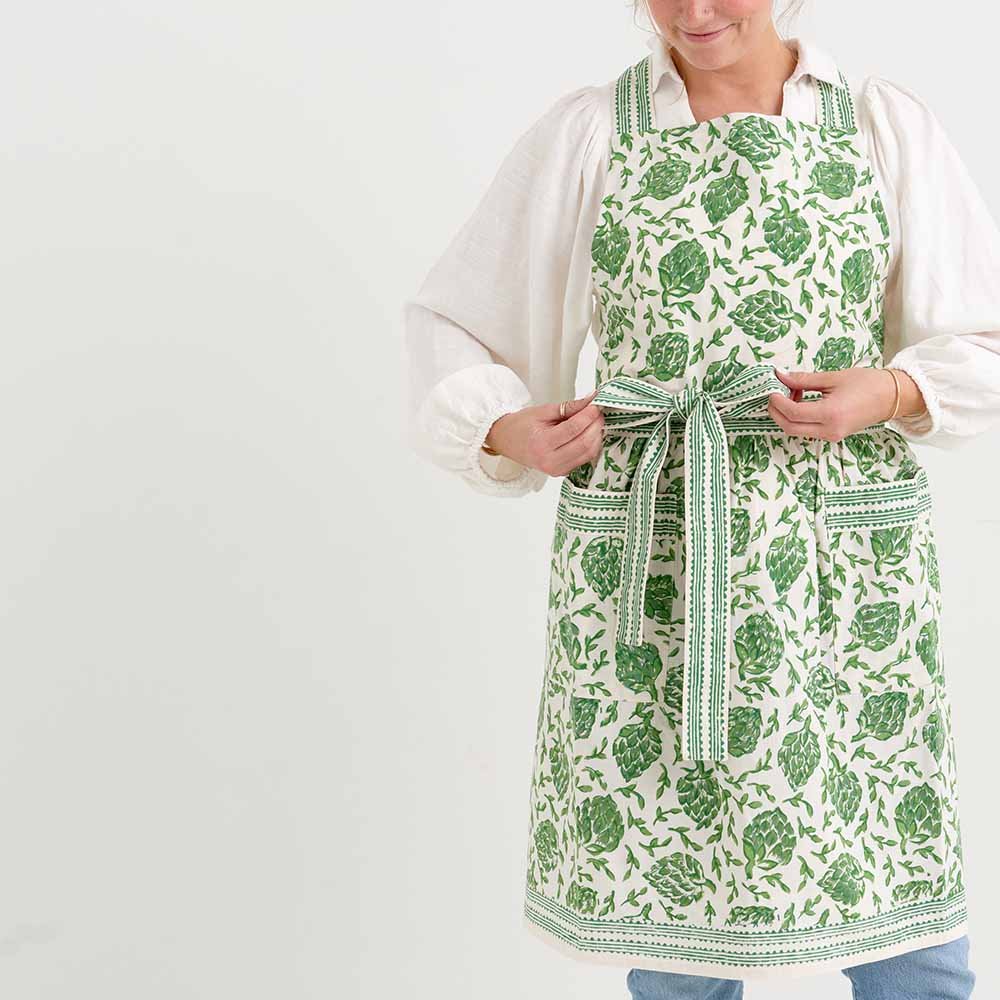 Dancing Artichokes Green Apron is a staple for any chef. With adjustable ties and an intricate outline, this apron combines cooking and fashion. 