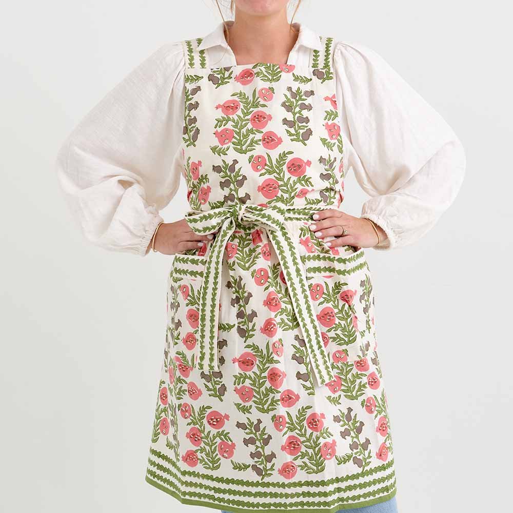 Pom Bells Fern & Poppy Apron with ties behind the neck and at the waist. 