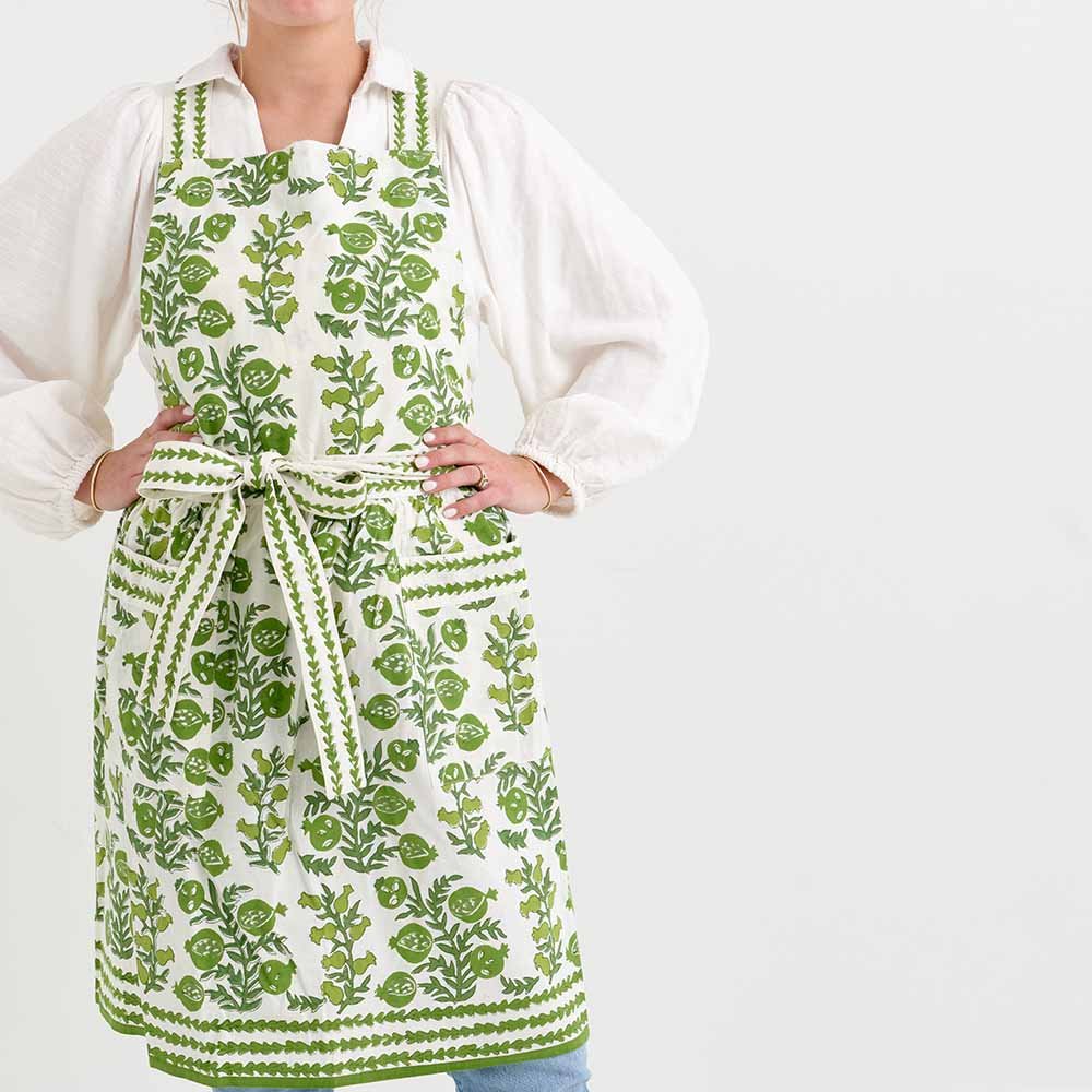 Pom Bells Green apron with ties behind the neck and around the waist. 