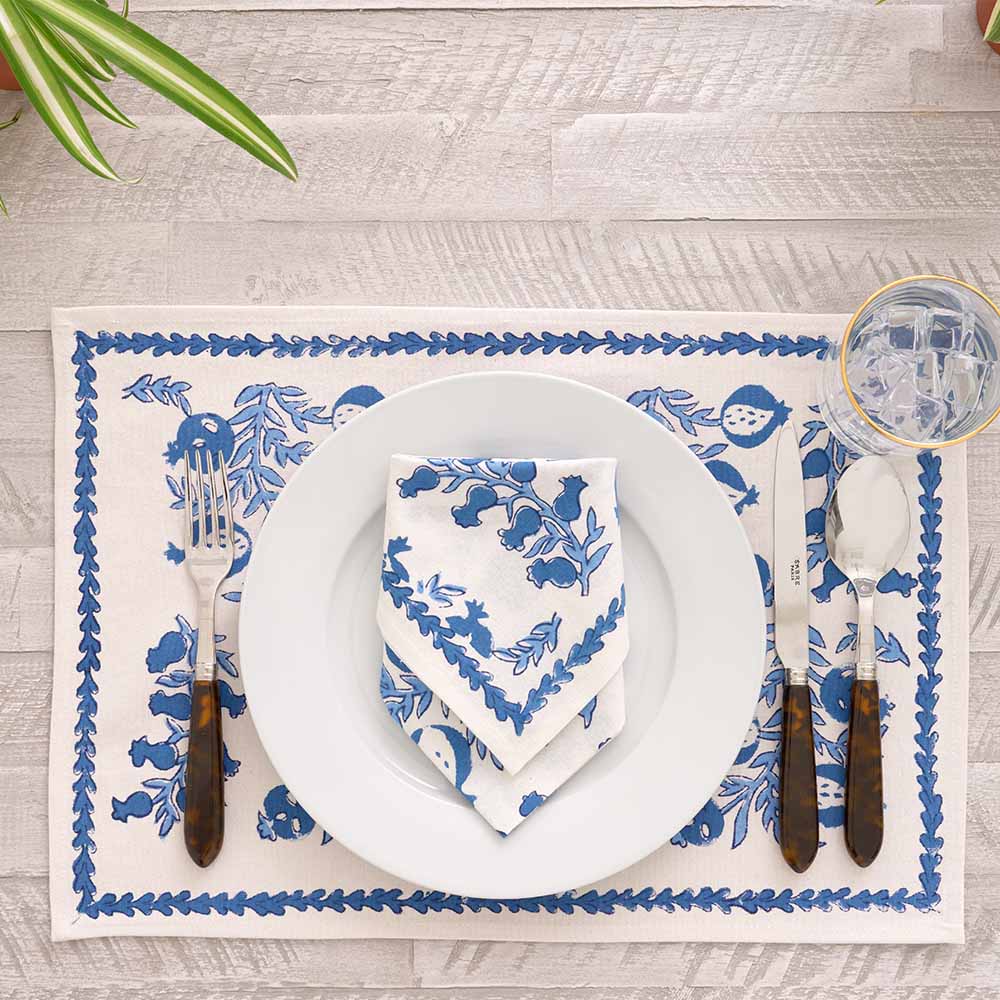 Folded napkin on white plate paired with matching placemat. 